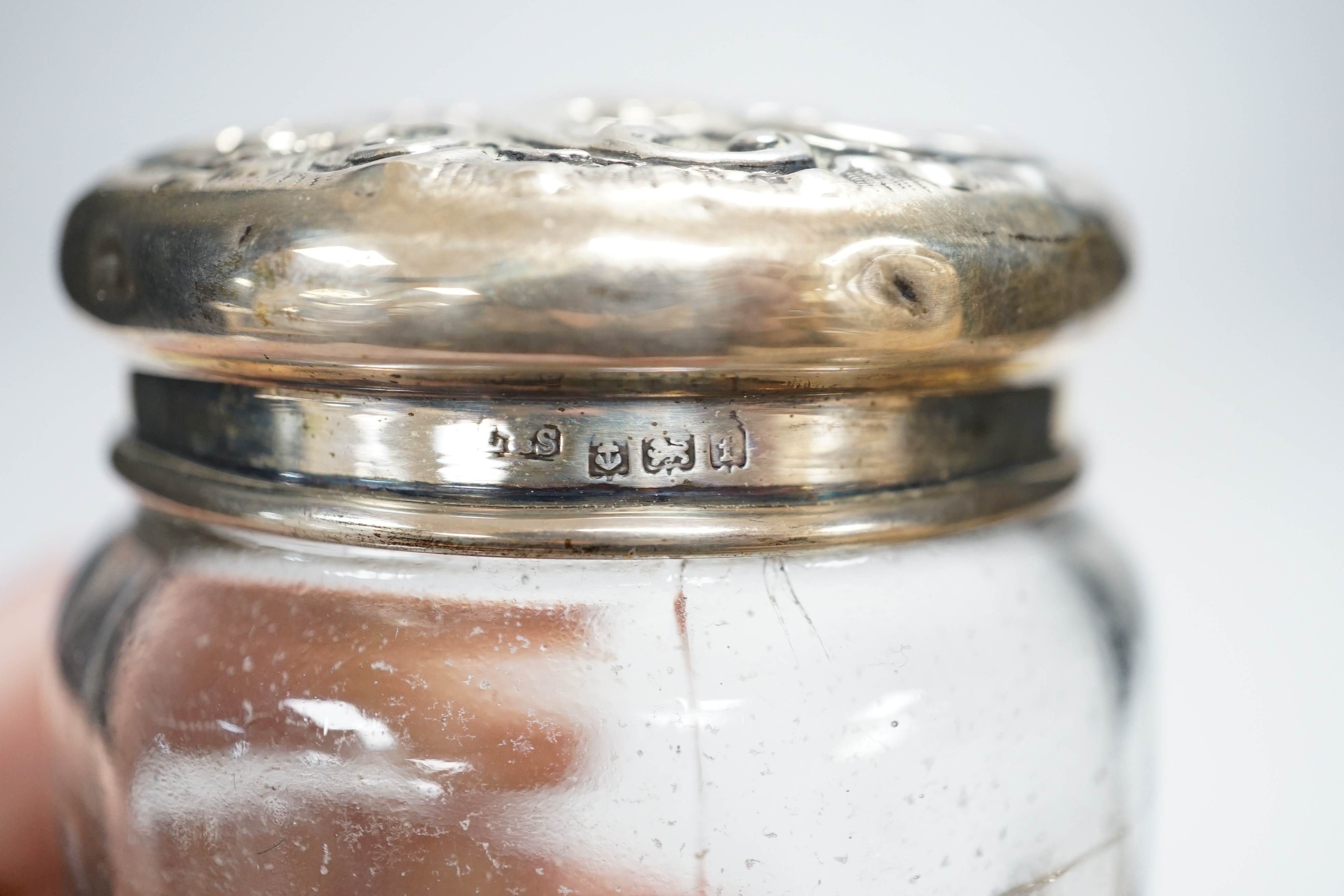 Sundry small silver including a silver mounted cigarette box, four assorted mounted glass toilet jars, a vesta case, button hook, hand mirror and trumpet vase.